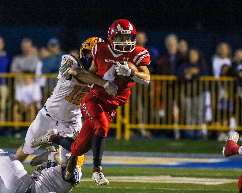 Hinsdale Central's Peter Hester (4) is tackled by Lyon's Davey Paulus (12) during football game between Hinsdale Central at Lyons.  Sept 8, 2023.