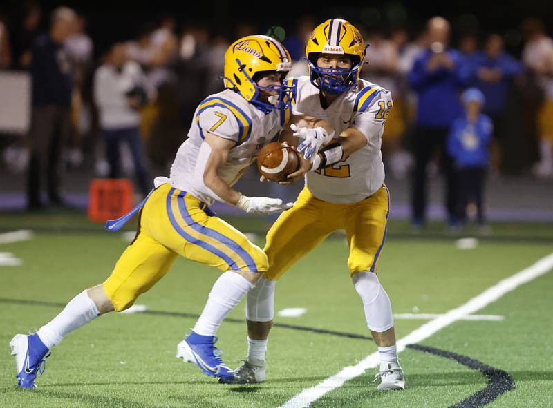 Lyons' Danny Carroll (7) takes a handoff from Dom Pisciotti  (12) during the varsity football game between Downers Grove North and Lyons Township in Downers Grove.