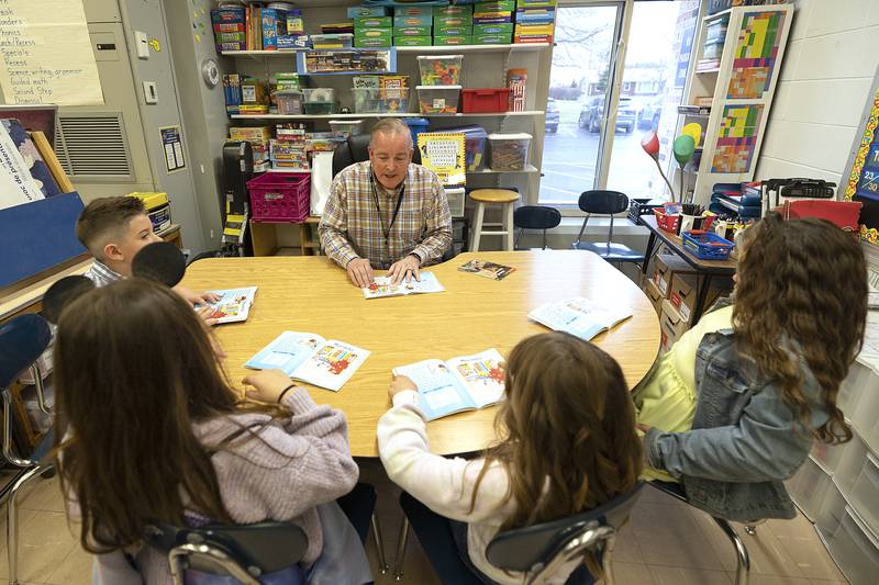 Brian Lobdell, a second grade teacher at Franklin Elementary School in Sterling, works with students on individual reading comprehension Thursday, March 27, 2025.