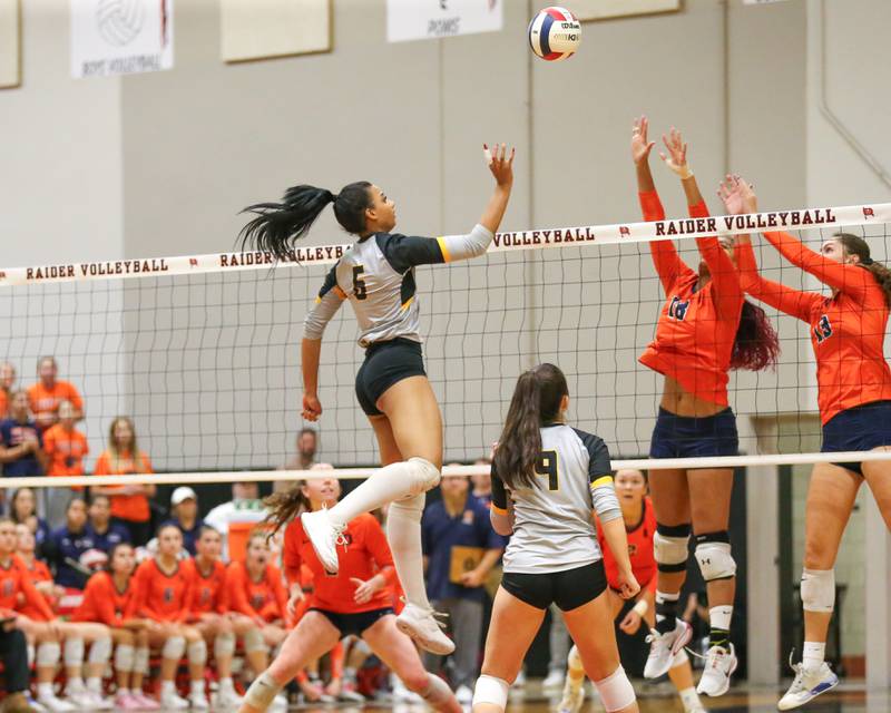Joliet West's Faith Jordan (6) tips a ball over the net during Class 4A Bolingbrook Sectional semifinal match between Joliet West at Oswego.  Nov 5, 2024  in Bolingbrook.