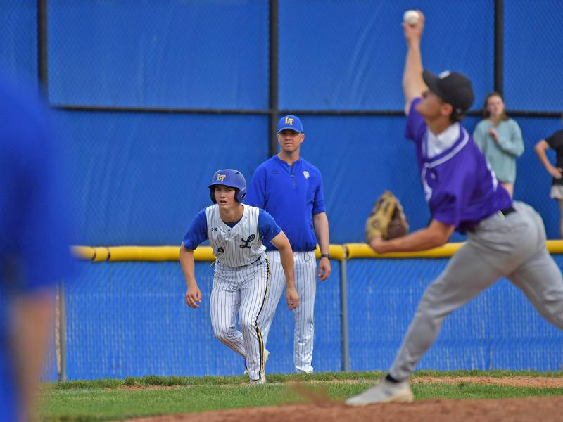 Lyons Township’s Brady Koren leads off third base while watching Downers Grove North pitcher Will Tomy during a game on May 18, 2026 at Lyons Township High School in LaGrange.