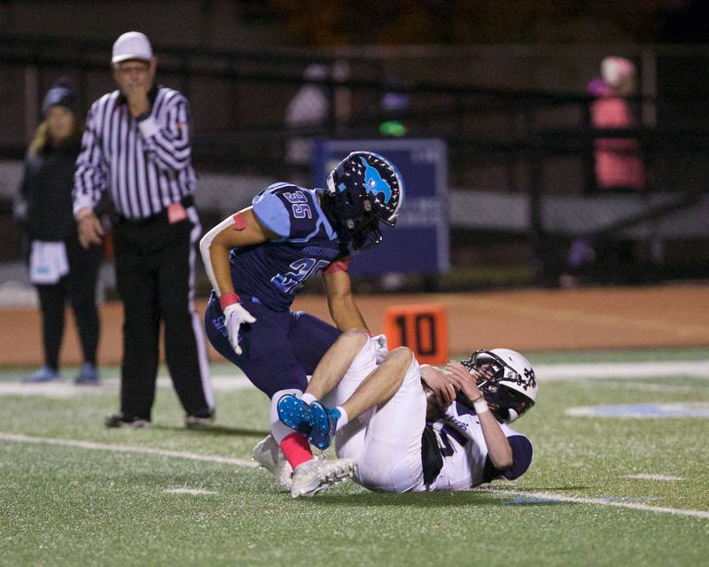 Addison Trails Nico Dill is sacked by Downers Grove South's RJ Samuels on Friday, Oct.20,2023 in Downers Grove.