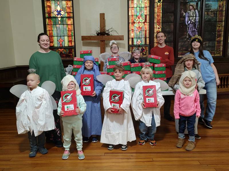 The Plano Methodist Church Sunday School staff and children with the Operation Christmas Child boxes.