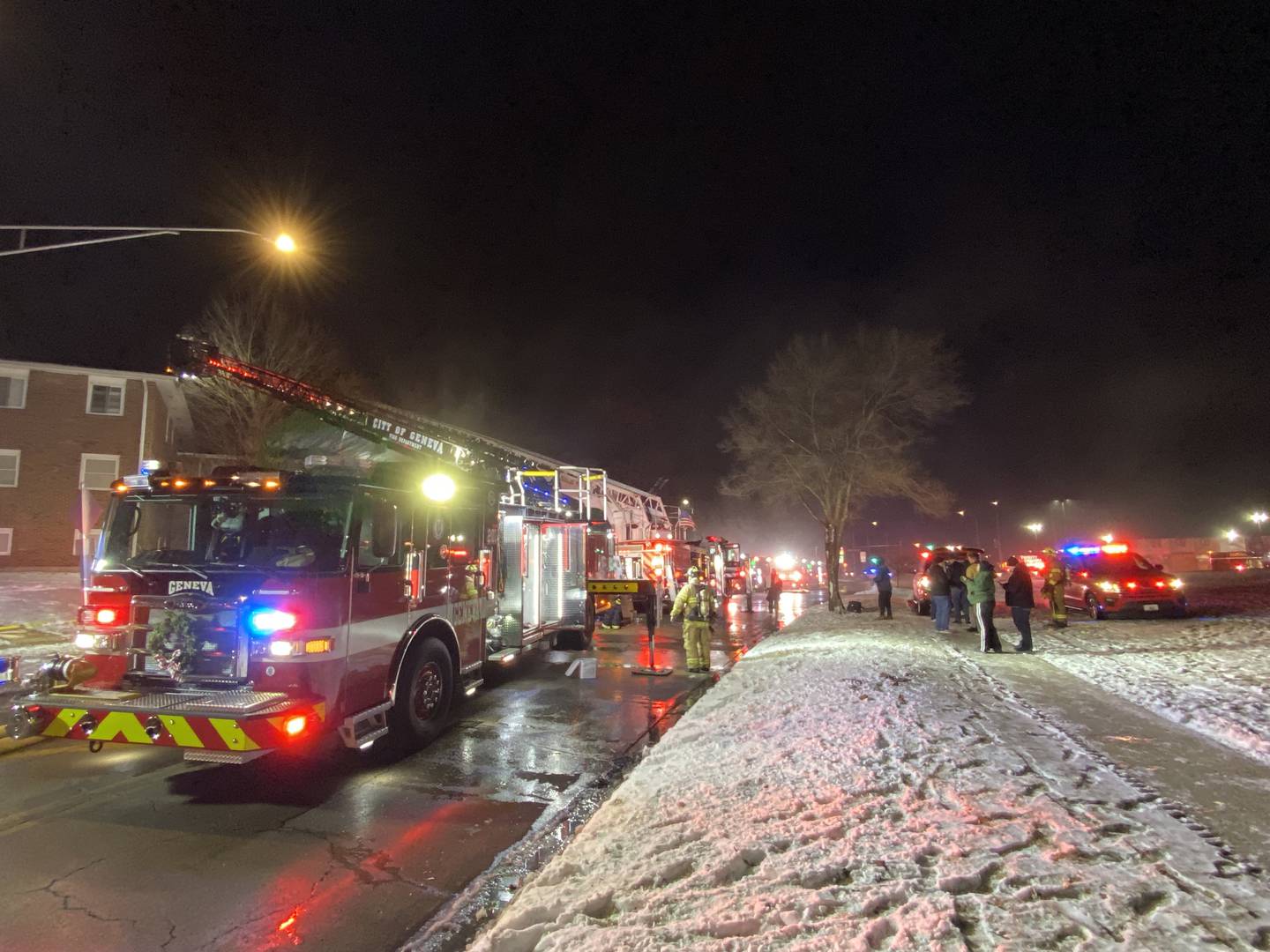Shaw Local file – Bystanders, emergency crews, and city officials including Fire Chief Mike Thomas, watch as firefighters battle a blaze at 1024 W. Hillcrest Drive, DeKalb on Sunday, Dec. 22, 2024.