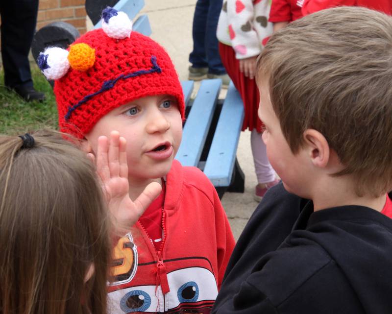 Marshall Morong, (left) 7, a first grader at Hinckley-Big Rock Elementary School, talks to a classmate Monday, May 5, 2025, after he arrived for his first day back at school following months waiting for, and eventually receiving, heart transplant surgery at Lurie Children’s Hospital of Chicago. Morong arrived in style in a Tesla Cybertruck donated for use by Telsa of Naperville, along with an escort by Hinckley and Big Rock first responders.