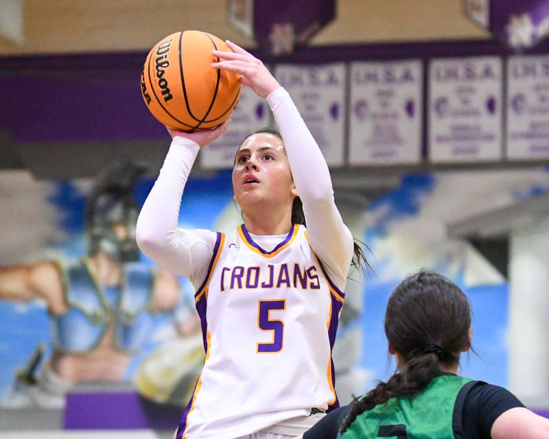 Downers Grove North's Campbell Thulin (5) takes a shot during the game on Tuesday Dec. 3, 2024, while being defended by York's Anna Filosa held at Downers Grove North High School.