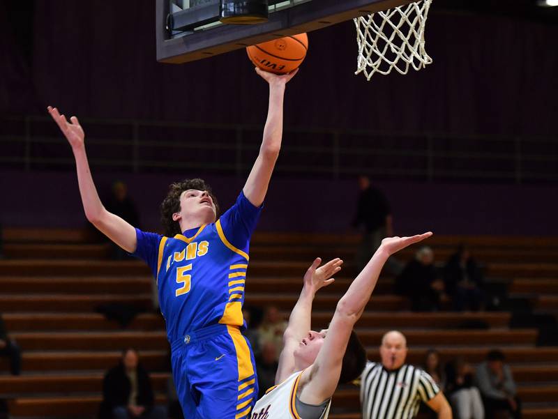 Lyons Township’s Owen Carroll (5) shoots over Downers Grove North’s Connor Crowley during a game on January 15, 2026 at Downers Grove North High School in Downers Grove .
