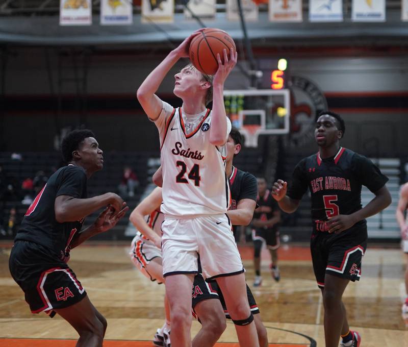 St. Charles East's Andrew Wolfsmith (24) plays the ball in the post against East Aurora during the 64th annual Ron Johnson Thanksgiving Basketball Tournament at St. Charles East High School on Monday, Nov 20, 2023.