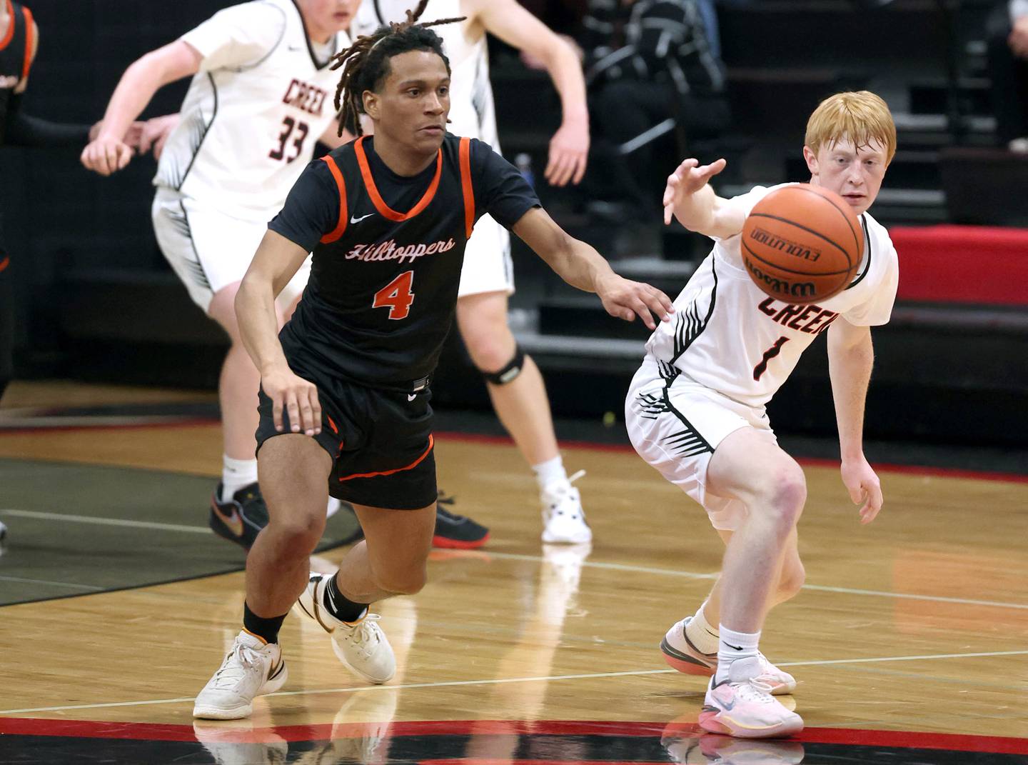 Elgin Academy's Camren Horton and Indian Creek's Tyler Bogle go after a loose ball during their game Tuesday, Dec. 18, 2023, at Indian Creek High School in Shabbona.