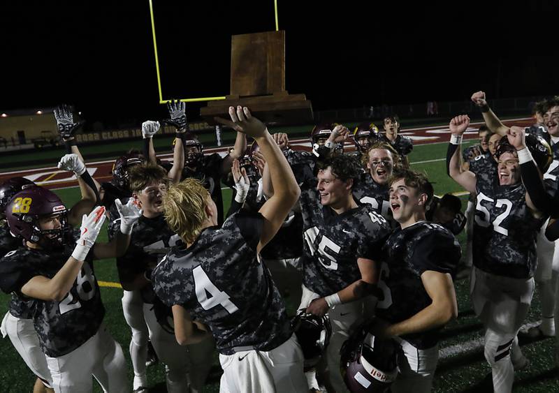 Richmond-Burton's Ray Hannemann raises the conference championship trophy after Richmond-Burton defeated Marengo in a Kishwaukee River Conference football game on Friday, Oct. 17, 2025, at Richmond-Burton High School in Richmond.