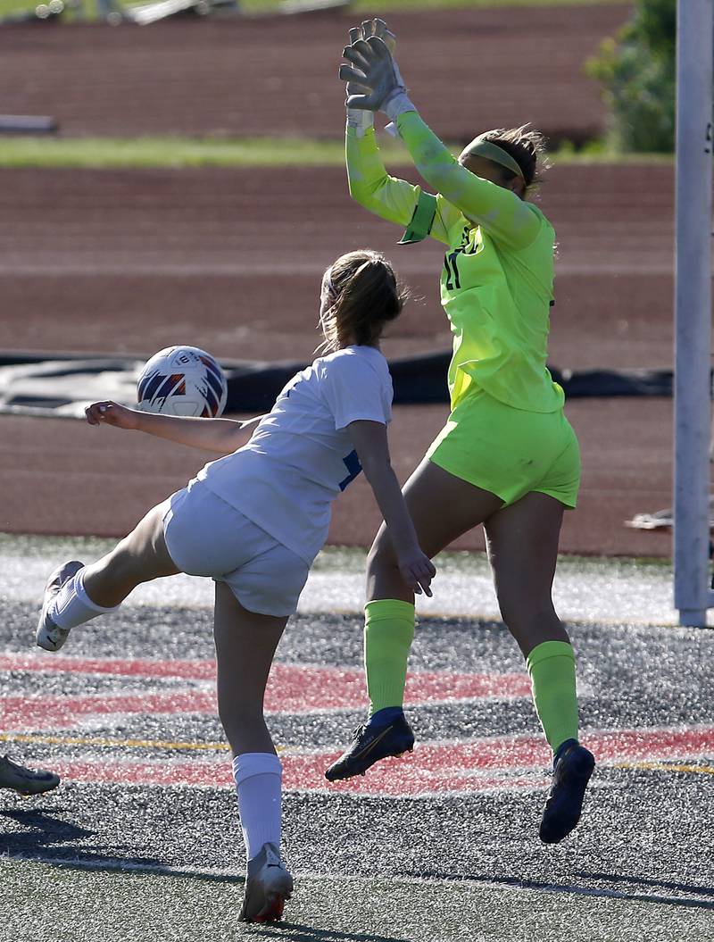 Lake Forest's Madelyn Cummins kicks tries to kick the ball past Crystal Lake Central's Addison Cleary during a Class 2A Deerfield Sectional semi-final match on Tuesday, May 21, 2024, at Deerfield High School.