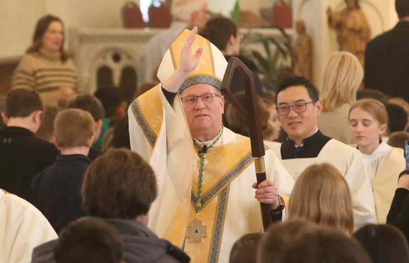The Most Reverend Bishop Louis Tylka, Bishop of Peoria, blesses students with Trinity Catholic Academy, Oglesby Holy Family and Peru Catholic Schools during a All Schools Mass on Thursday, Feb. 20, 2025 at St. Patrick's Catholic Church in La Salle. The bishop announced a new name for the three schools calling it Carlo Acutis. Last year, the Catholic Diocese of Peoria announced the consolidation of the three schools. Carlo Acutis Canonization will take place on Sunday, April 27, 2025 during the Jubilee of Teenagers in Rome. Acutis is the first millennial saint, representing those born between the early 1980's and the late 1990's. He is celebrated for cataloging miracles and online and managing websites for Catholic organizations.