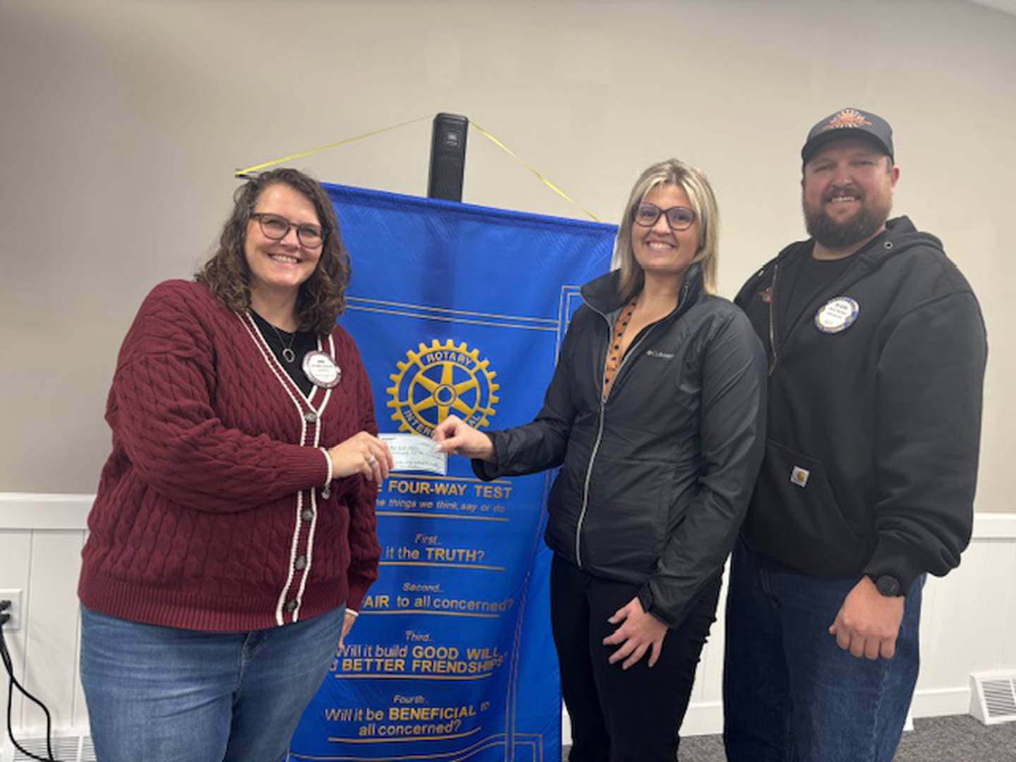 Rock Falls Rotary donated $250 to support the non-profit organization Path to the Future which provided meals to 72 families at Thanksgiving and 110 families at Christmas in our community. President Jenn Schultz (left)  presents the check to organization  founders Emily
Juist and Devon Nicklaus (right).
