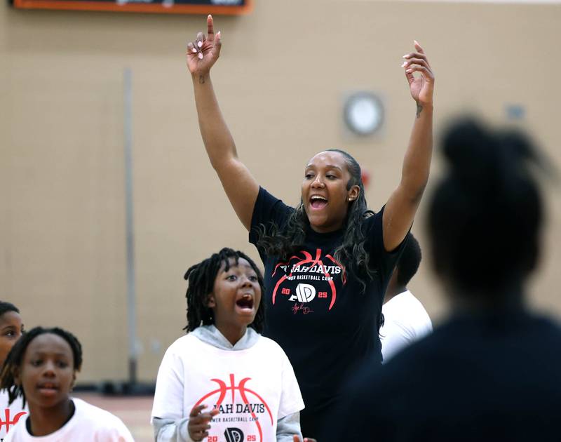 DeKalb native and former Northern Illinois University basketball player A'Jah Davis celebrates with her team during a relay race Saturday, May 24, 2025, at her A'Jah Davis Foundation Basketball Camp and Wellness Day at DeKalb High School.