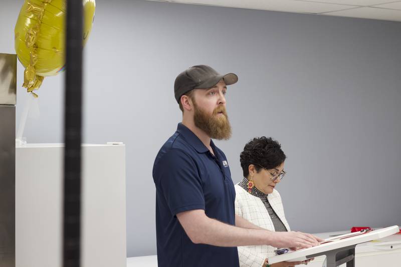 Skyler Reed (left), Joliet Township food pantry coordinator, delivers a speech on Monday, April 21, 2025, as part of a ribbon-cutting ceremony for the food pantry at the township's Forest Park Community Center in Joliet.