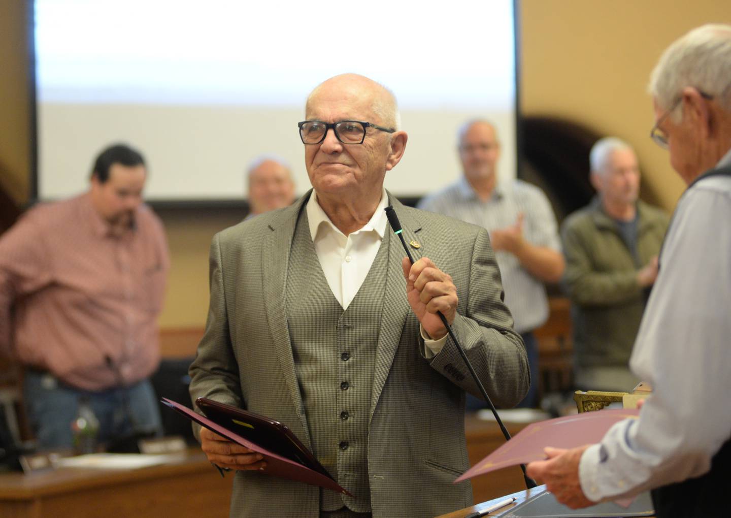 District 2 Ogle County Board Member Tom Smith of Rochelle, speaks after receiving a certificate of recognition from Board Chairman John Finfrock of Mt. Morris (right) at the Ogle County Board meeting on Tuesday, Nov. 19, 2024. Smith is retiring from the board and attended his final board meeting on Tuesday.