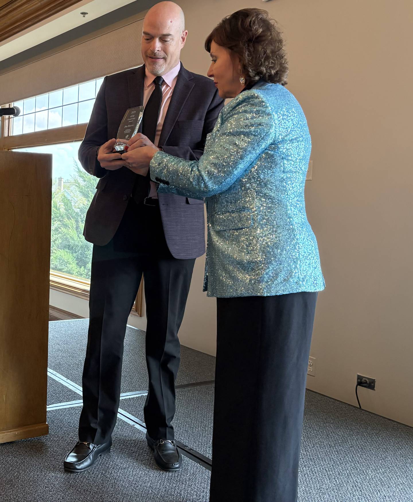 GEM Award winner Jim Haisler, left, receives his award from Kathleen Caldwell, Crystal Lake Chamber Foundation chair emeritus, at the GEM Leadership Celebration in Lake in the Hills Thursday, April 23, 2026.