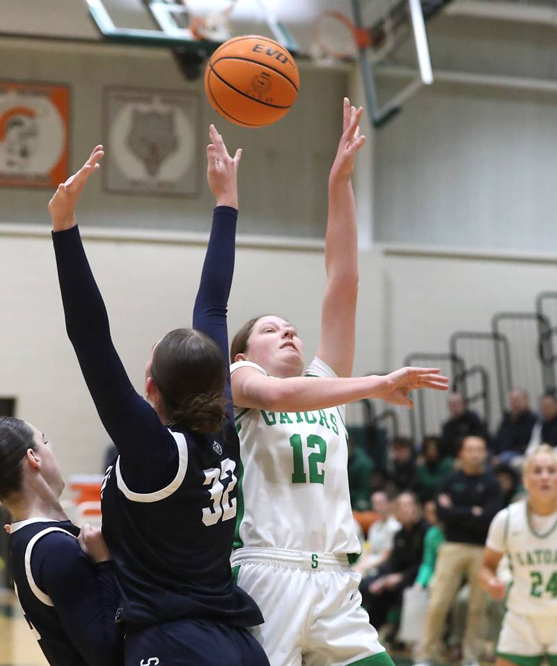Crystal Lake South's Gaby Dzik shoots the ball over Cary-Grove's Olivia Leuze during a Fox Valley Conference girls basketball game on Friday, Jan. 23, 2026, at Crystal Lake South High School.
