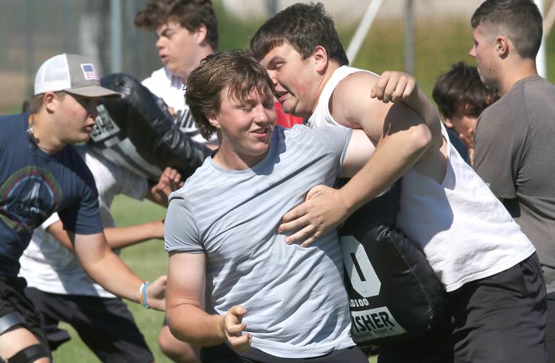 Sycamore defensive linemen work through a drill Monday, June 27, 2022, during football practice at the school.