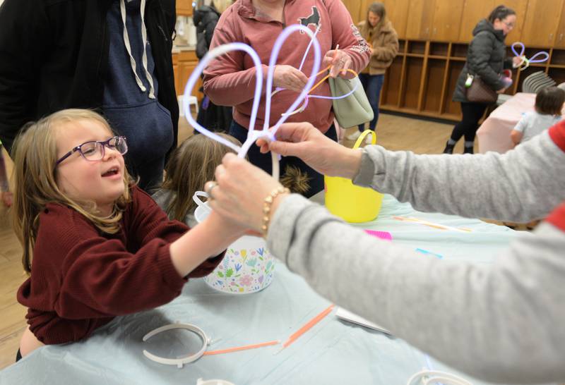 Children including Sydney Stein of Downers Grove enjoy making bunny ears during the Downers Grove Bunny Hop Egg Hunt Friday, March 22, 2024.