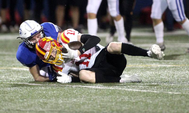 Batavia’s Patrick McNamara holds onto the ball as he’s taken down by Geneva’s Rocco Lampiasi during a game in Geneva on Friday, Sept. 29, 2023.