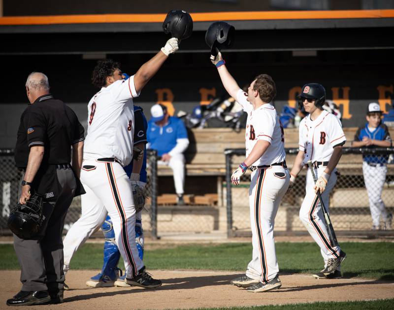 Beecher's Ryan Cruz, left, and Steven Fezler, right, touch helmets after Cruz's 2-run home run in the sixth inning of a game against Central on April 29,2025.