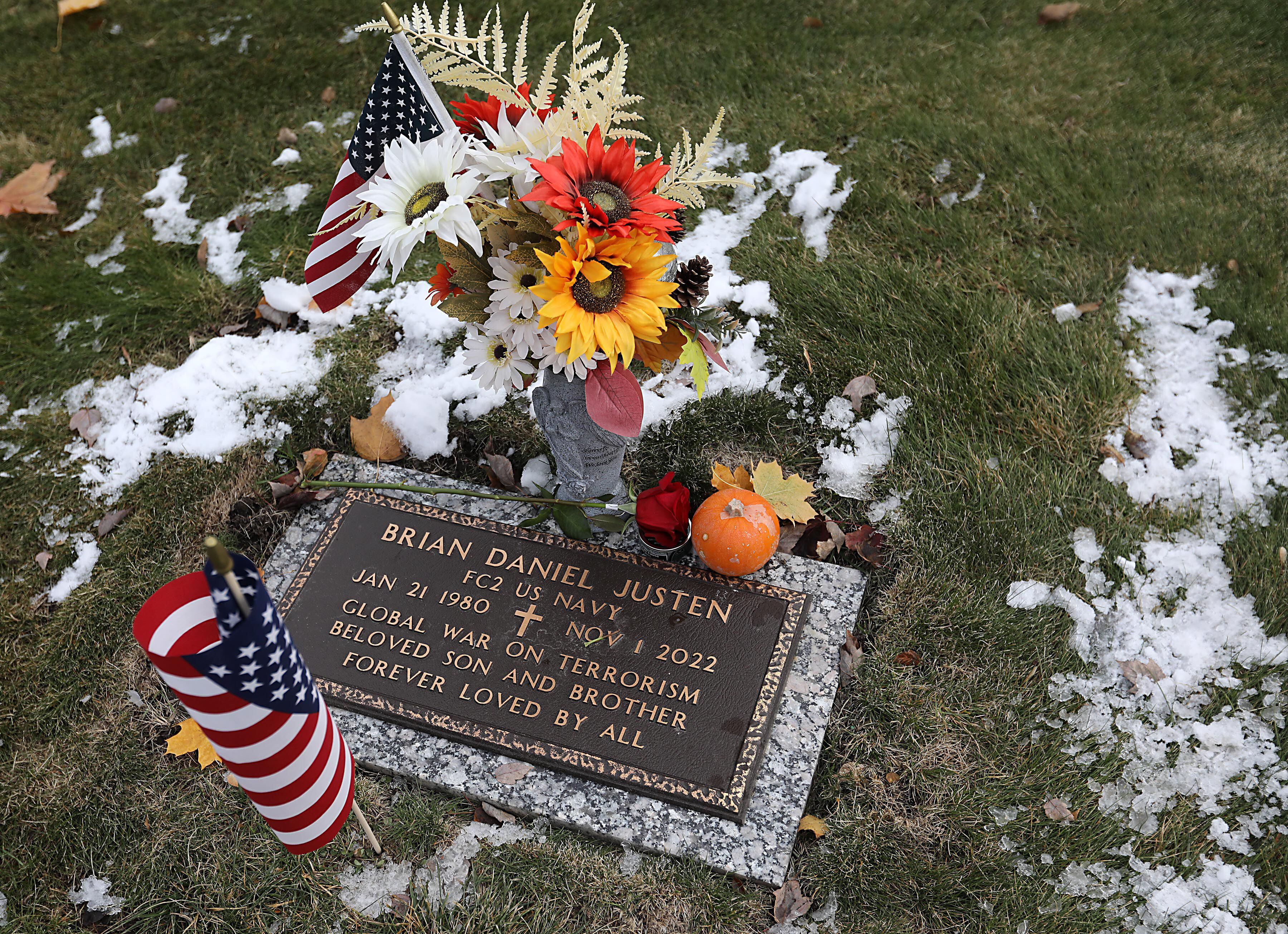 A flag graces the gravesite of U.S. Navy veteran Brian Daniel Justen during the Veterans Day flag placement ceremony Tuesday, Nov. 11, 2025, at the gravesites of veterans at McHenry County Memorial Park Cemetery in Woodstock.