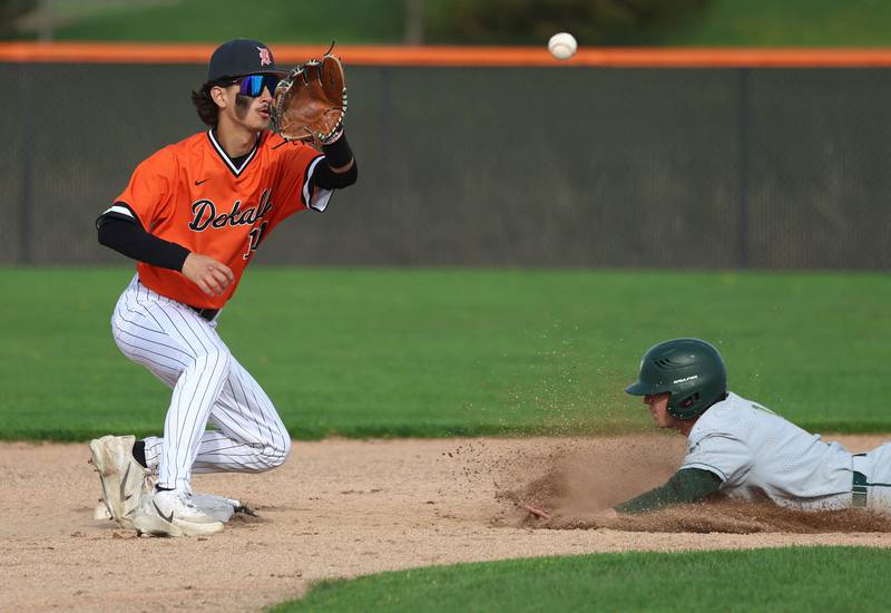Waubonsie Valley's Parker Howland slides into second with a stolen base as DeKalb's Benny Probst catches the throw Monday, April 20, 2026, during their game at DeKalb High School.