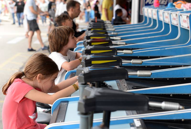 Parker and Patrick Nelson of LaGrange compete with others for a prize during the LaGrange Endless SummerFest Sunday Aug 6, 2023.