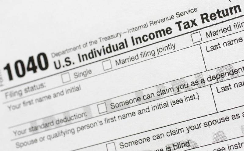 FILE - This July 24, 2018, file photo shows a portion of the 1040 U.S. Individual Income Tax Return form. The IRS began accepting and processing tax returns for individuals on Monday, Jan. 27, 2020. (AP Photo/Mark Lennihan, File)