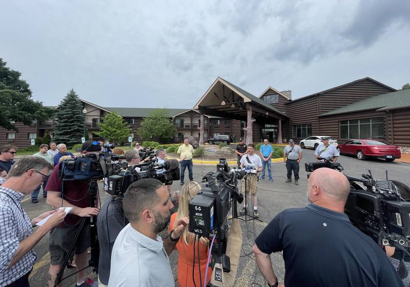 Chicago media stations interview Utica Fire assistant chief Drew Partain during a press conference at Grand Bear Lodge on Tuesday, May 31, 2022. A fire fueled by high winds destroyed 28 cabins on the property. No injuries were reported.