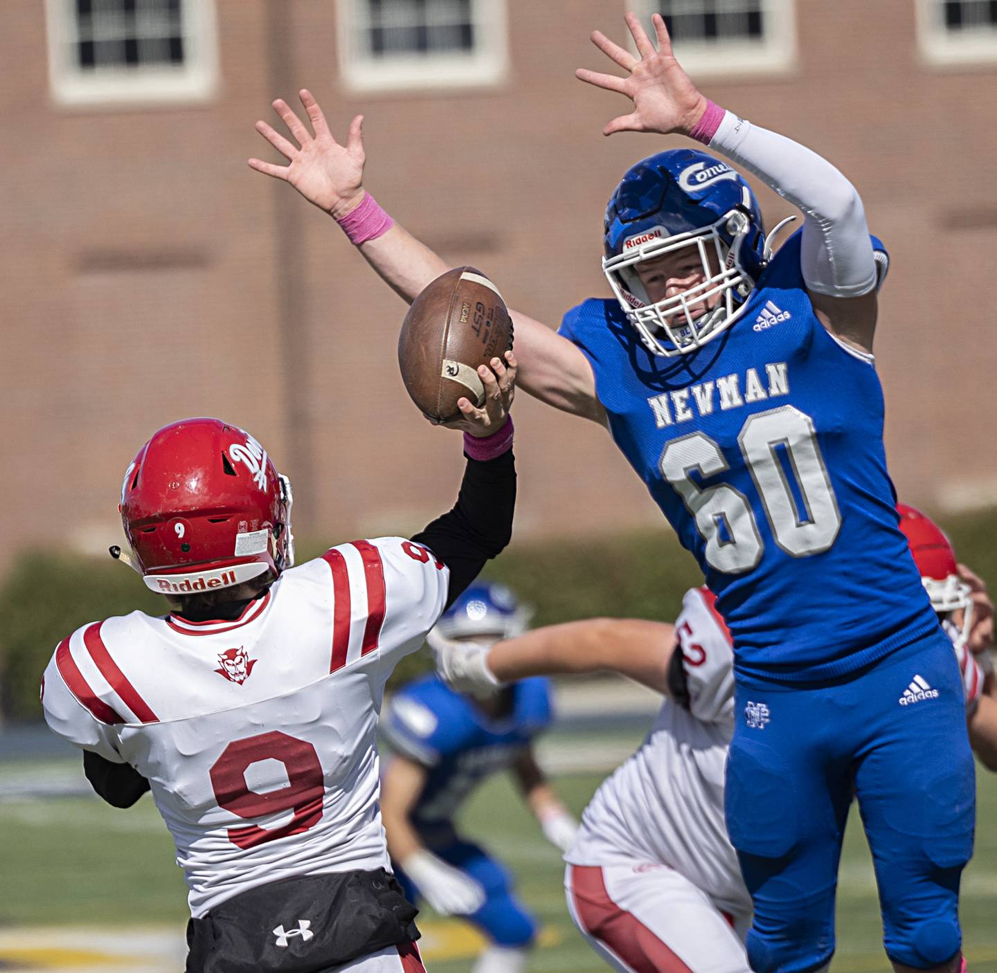 Newman’s Caleb Donna looks to block Hall QB Gianni Guerrini’s pass Saturday, Oct. 7, 2023.