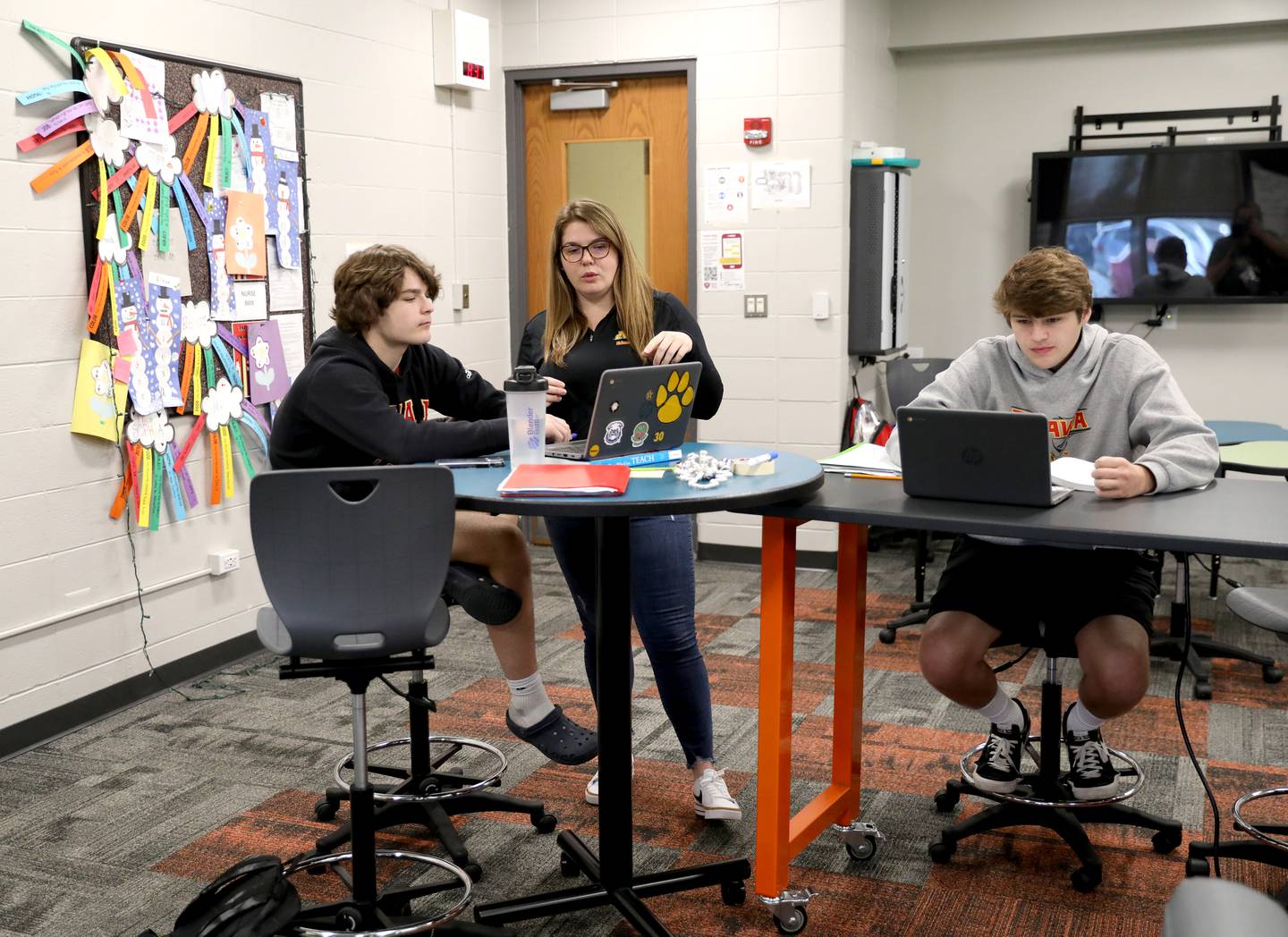 Batavia High School Early Childhood Instructor Austen Savitski (right) works with junior and aspriring teacher Chloe Ford.