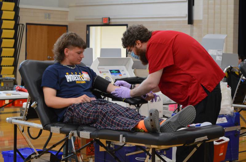 Polo Community High School senior Wyatt Queckboerner, 18, watches as American Red Cross worker Josh Bornsheuer inserts a needle to take Queckboerner's blood. The teen donated blood on April 28 during his lunch break. The Polo Student Council hosted the blood drive with the American Red Cross.