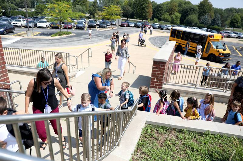 Pre-school students climb the stairs of Fabyan Elementary School during the first day of school for the Geneva Early Learning Program on Monday, Aug. 21, 2023.