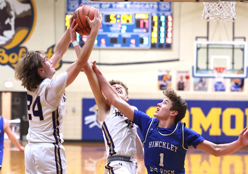 Serena's Camden Figgins (left) and Carson Baker pull a rebound away from Hinckley-Big Rock's Tyler Smith Friday, Feb. 3, 2023, during the championship game of the Little 10 Conference Basketball Tournament at Somonauk High School.