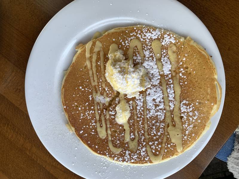 Maple & Hash Churro Pancakes ($13) pancakes dusted with cinnamon sugar, topped with whipped butter, powdered sugar and vanilla anglaise.