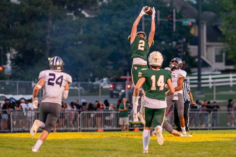 Waubonsie Valley's Julian Johnson (2) catches a pass against Oswego East during a football game at Waubonsie Valley High School in Aurora on Friday, Aug. 25, 2023.