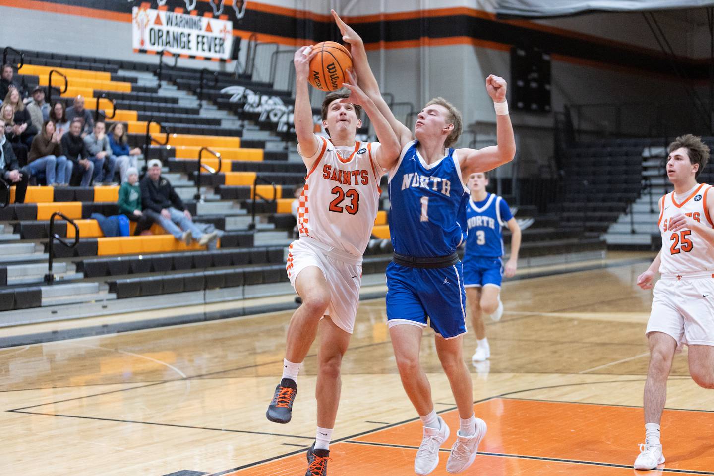St. Charles East's Peyton Faidley is fouled by Wheaton North's Henry Schlickman on Saturday, Dec.13,2025 in St. Charles.