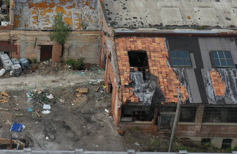 An aerial view shows where firefighters cut open the roof of the storage area behind the historic Westclox building on Monday, July 17, 2023 in Peru. The building caught fire last Friday when an unattended fire behind the the building  was the cause of the larger fire in the building.