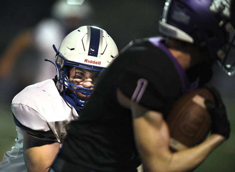 Vernon Hills’ Gio Urso catches Rolling Meadows’ Ben Petermann in a football game in Rolling Meadows on Friday, September 9, 2022.