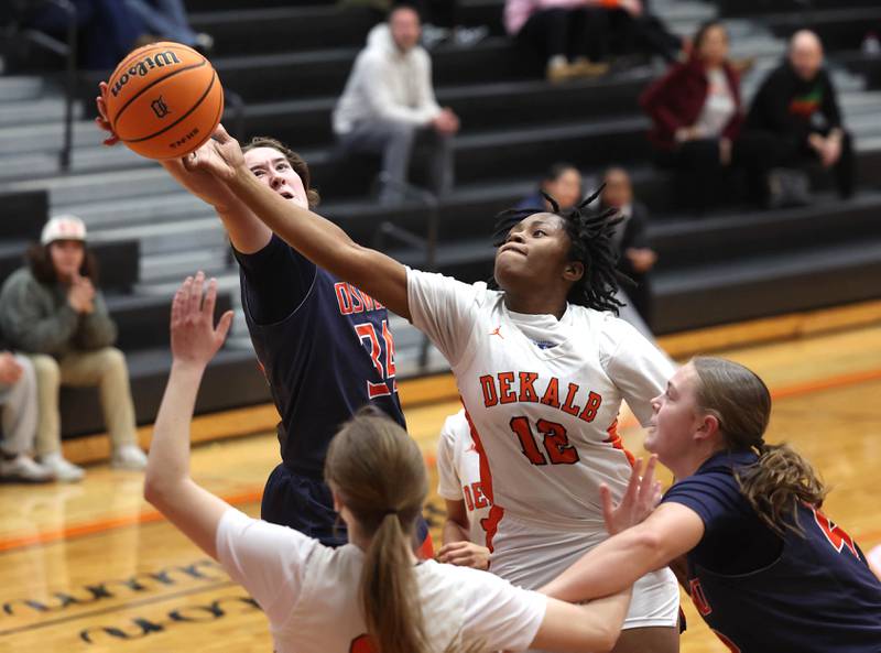 DeKalb's Angela Gary and Oswego's Kyla Baier go after a rebound during their game Monday, Jan. 5, 2026, at DeKalb High School.