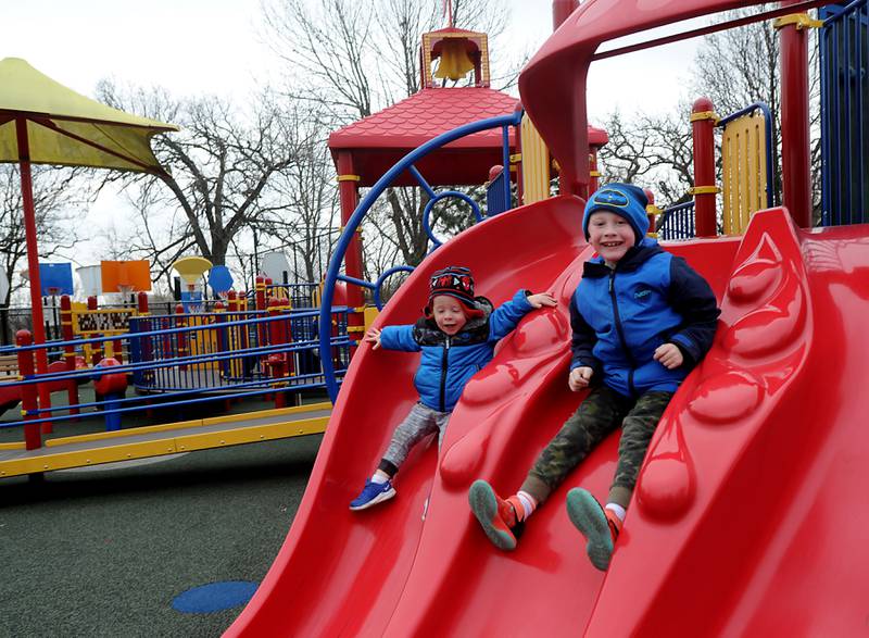 Matthew Underwood, right, 7, of Huntley, goes down the slide with his brother, Ethan, 2, Wednesday, April 20, 2022, as they play at Deicke Park in Huntley, which features an accessible playground. Woodstock plans on building an inclusive playground that is meant to be more accessible for children with handicaps or disabilities at Emricson Park.