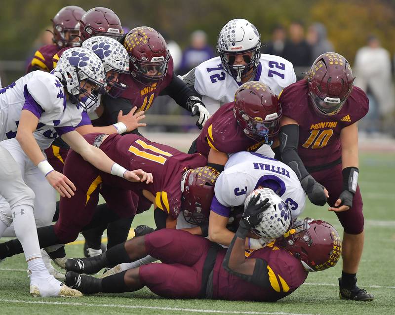The Montini defense smothers Wilmington's Ryan Kettman (3) during a Class 3A semifinal game on November 23, 2024 at Montini Catholic High School in Lombard.