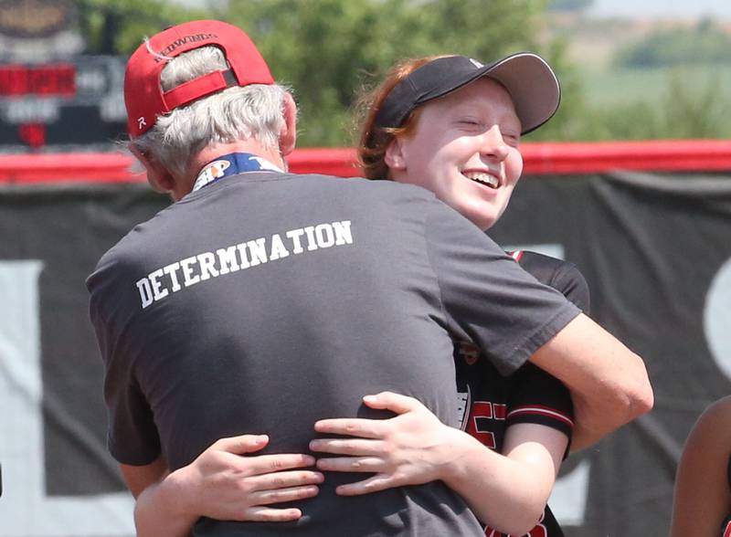 Benet Academy's Marikate Ritterbusch hugs head coach Jerry Schilf after winning the Class 3A State third place game on Saturday, June 10, 2023 at the Louisville Slugger Sports Complex in Peoria.