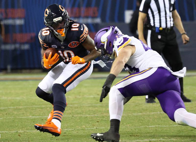 Chicago Bears wide receiver Luther Burden III tries to avoid the tackle of Minnesota Vikings linebacker Andrew Van Ginkel during their game Monday, Sept. 8, 2025, at Soldier Field in Chicago.