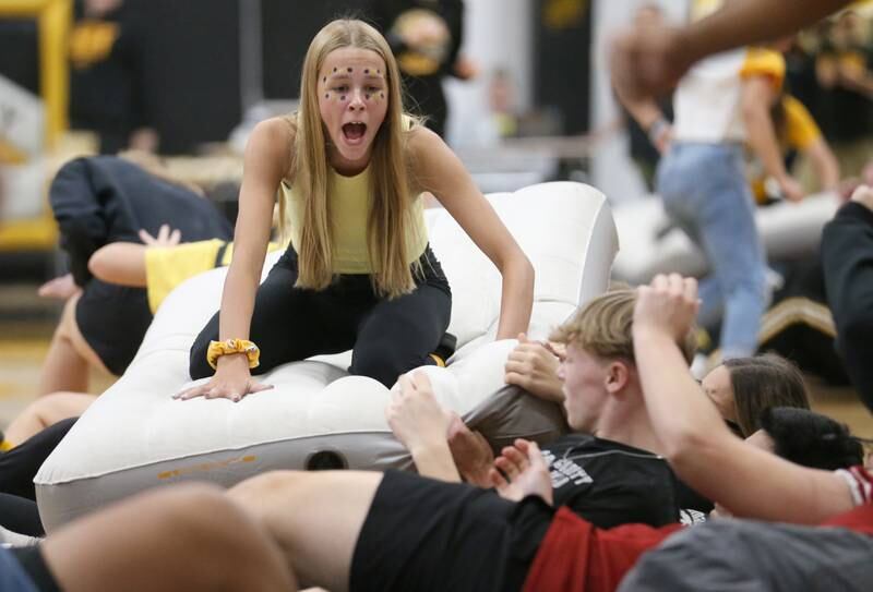 Putnam County High School student Sara Wiesbrock ride an air mattress during the "ride the wave" game during the football Homecoming Pep Rally on Friday, Sept. 27, 2024 at Putnam County High School in Granville.