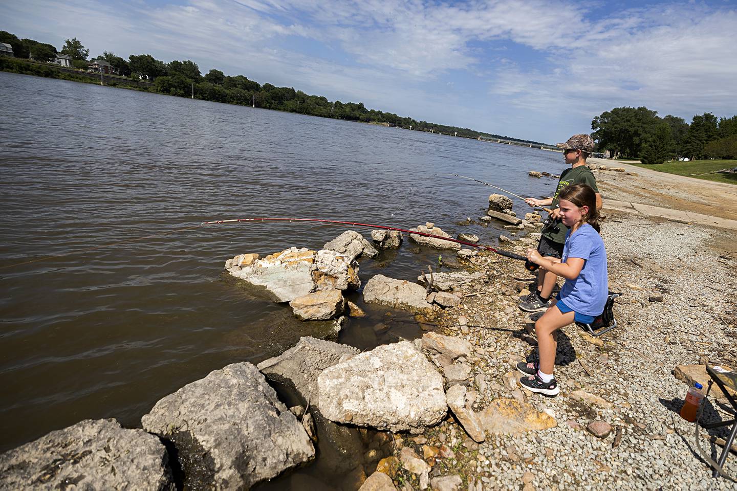 Gabby, 7, and Grady Staats, 14, of Sterling try a little fishing along the Rock River on Tuesday, July 2, 2024, at Seward’s Park in Rock Falls. With more rain expected, the National Weather Service has issued a flood watch from 3 p.m. Tuesday until 2 a.m. Wednesday. Most of the threat is on the Mississippi River and toward the Quad-Cities.