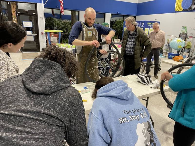 Alex Lamers of Working Bikes Chicago walks participants through bike maintenance at SCARCE's most recent repair workshop. The workshops focus on reducing waste by not only repairing broken things, but also by choosing high-quality items, maintaining them well and, if possible, recycling them at the end of life. (Photo courtesy of SCARE)