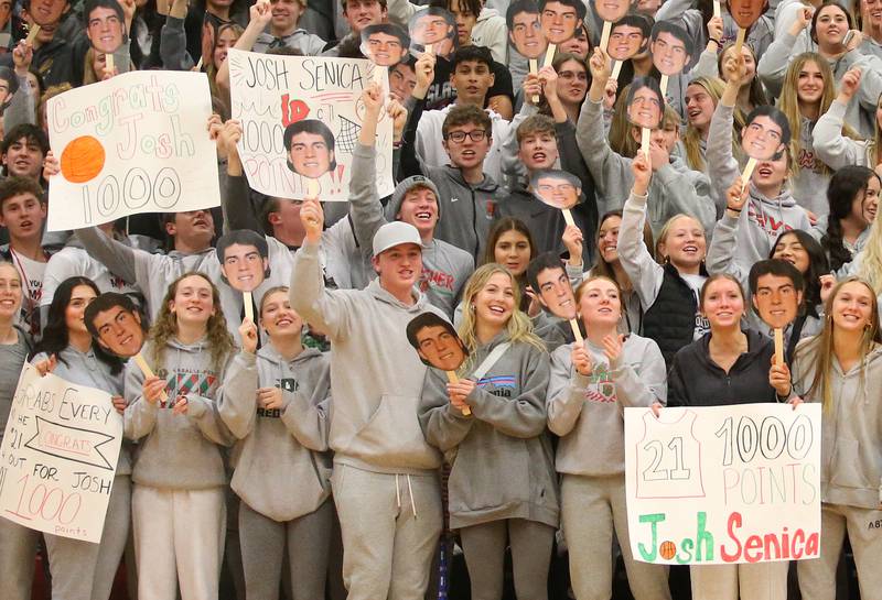 L-P super fans hold signs and faces honoring senior Josh Senica after scoring 1000 points in his high school career on Tuesday, Nov., 28, 2023 in AJ Sellett Gymnasium at L-P High School.